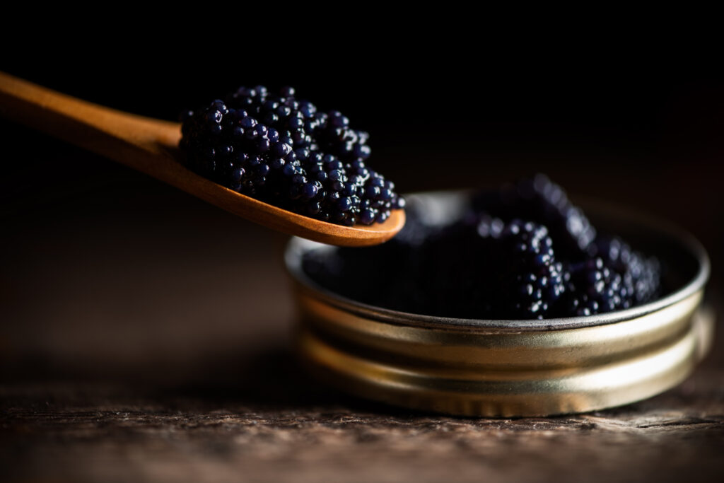 black lumpfish caviar in a small pot and spoon